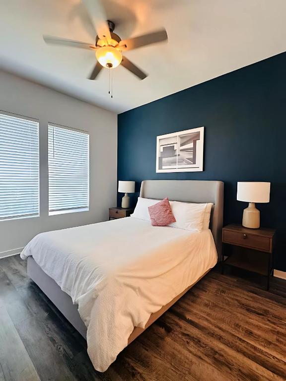 a bedroom with a large bed with a ceiling fan at Family-Friendly Home with Great Comfort in Leander