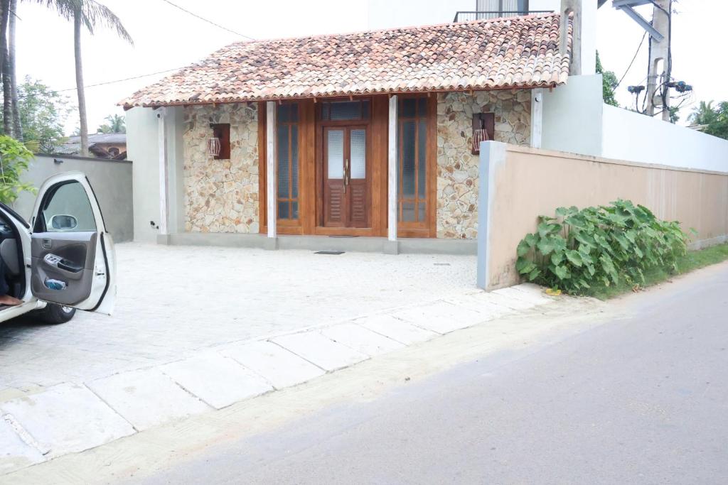 a small house with a door on a street at Handagedara Resort & Spa in Mirissa