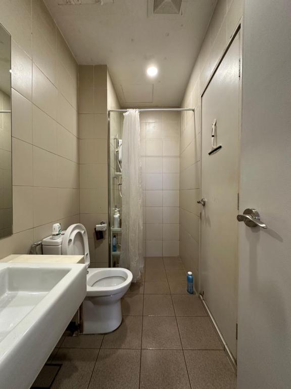 a bathroom with a toilet and a sink and a shower at AQ HOME at iSUITE, iCity, Shah Alam HomestayBnB in Kampong Padang Jawa