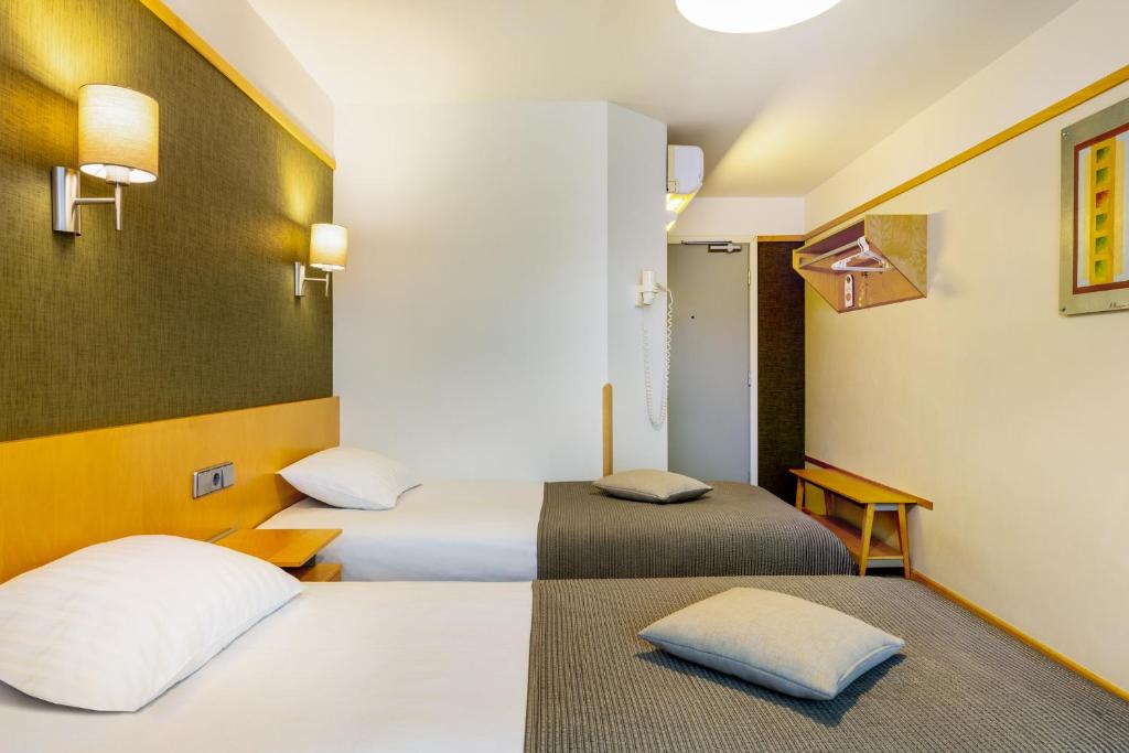 Postel nebo postele na pokoji v ubytování Hotel Tartu