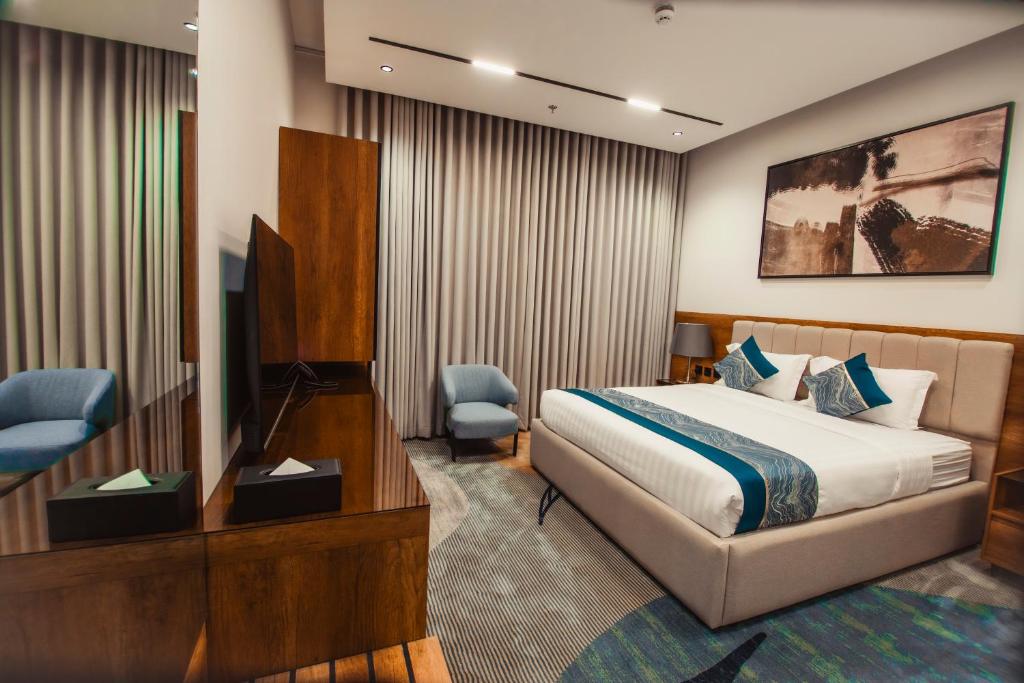 una habitación de hotel con una cama y un televisor en كنين للشقق الفندقية-Kanin Apartments, en Riad