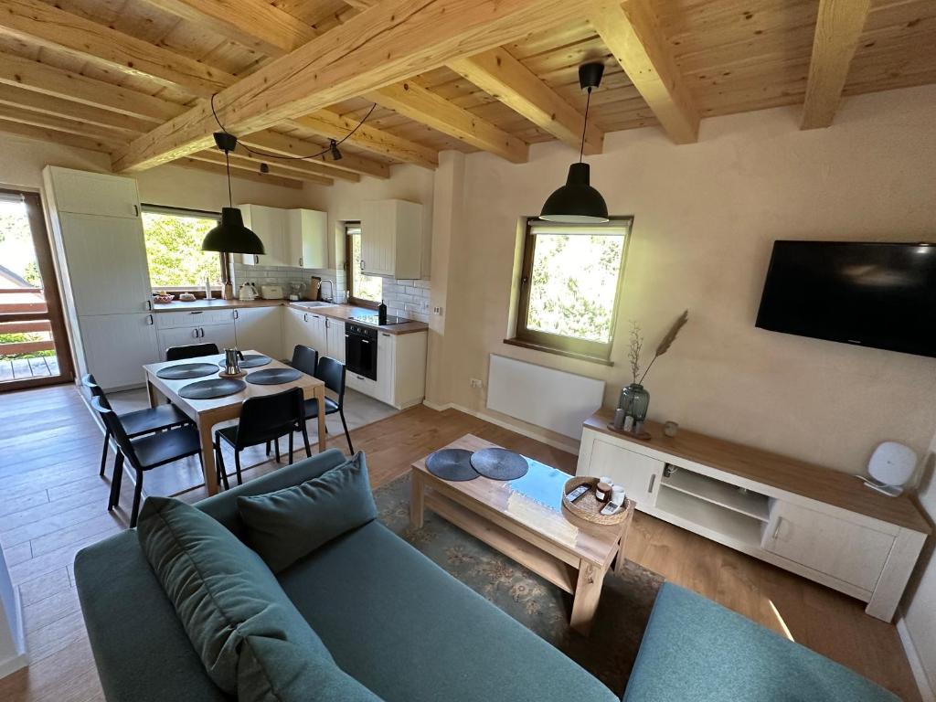 a living room with a blue couch and a table at Przystanek Zawóz in Zawóz