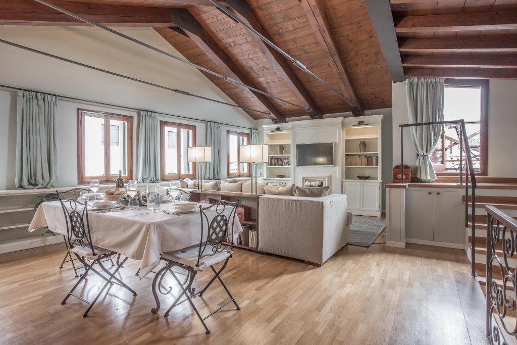 a dining room with a table and some chairs at Cà Grassi 3 Venetian Terrace in Venice