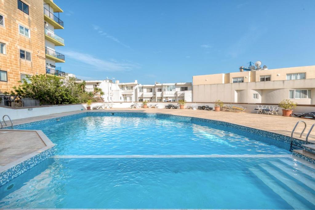 a large swimming pool in the middle of a building at Amazing apartment with pool in Malta in Is-Swieqi