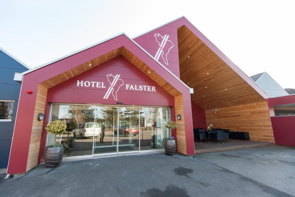 a hotel building with a sign on the front of it at Hotel Falster in Nykøbing Falster