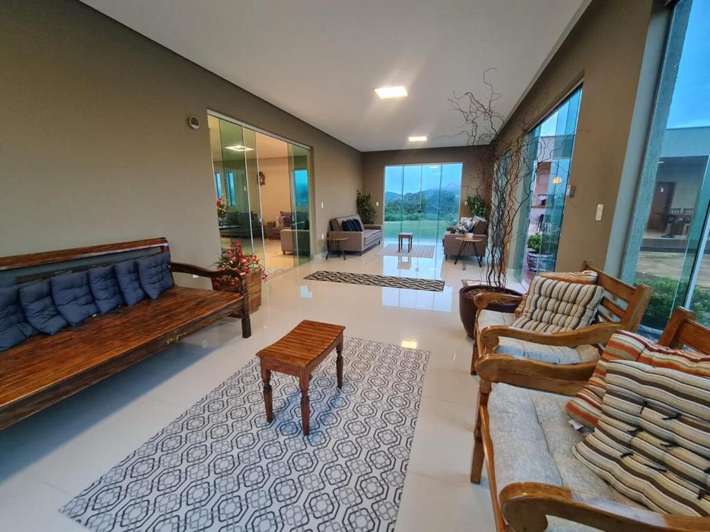 a large living room with couches and tables and windows at Mol Residence in Esmeraldas