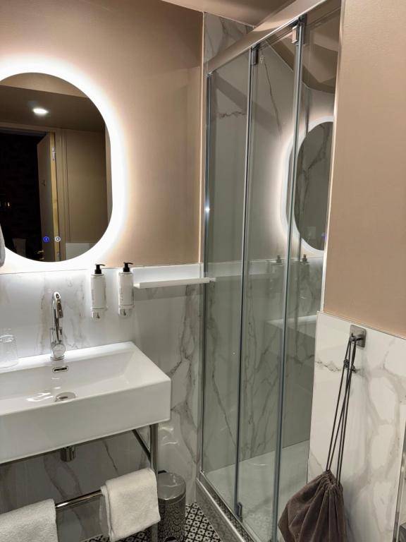 a bathroom with a sink and a shower at La Caravelle in Aix-en-Provence