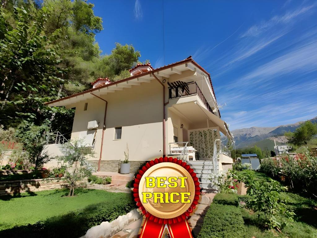 a best price sign in front of a house at Villa Vasil Mertiri in Himare