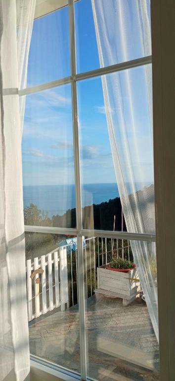 a window view of the ocean from a balcony at Message in a Bottle Bed and Breakfast in Camporosso