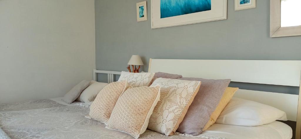 a bedroom with a bed with pillows on it at Message in a Bottle Bed and Breakfast in Camporosso