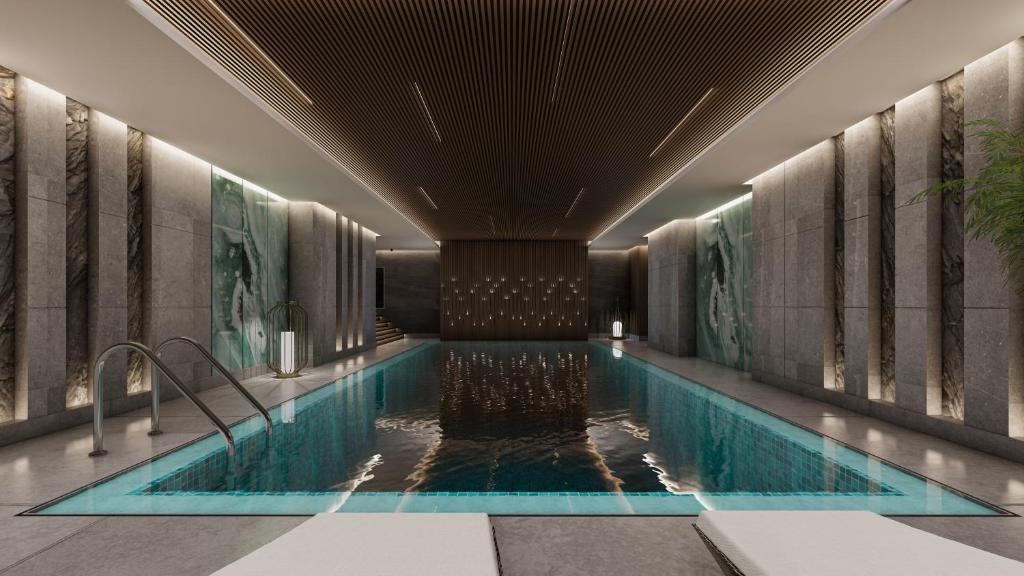 a swimming pool in the lobby of a hotel at voco Jeddah Gate by IHG in Jeddah