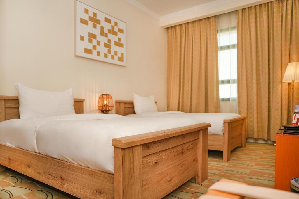 Posteľ alebo postele v izbe v ubytovaní Swiss-Belinn Doha