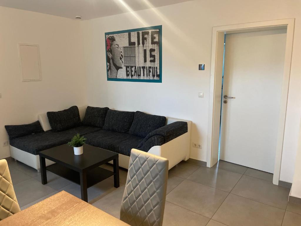 a living room with a couch and a table at Großkoschen Wohnungen in Senftenberg