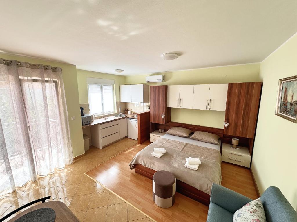 a large bedroom with a bed and a kitchen at Apartments Vila Miranda in Vodice