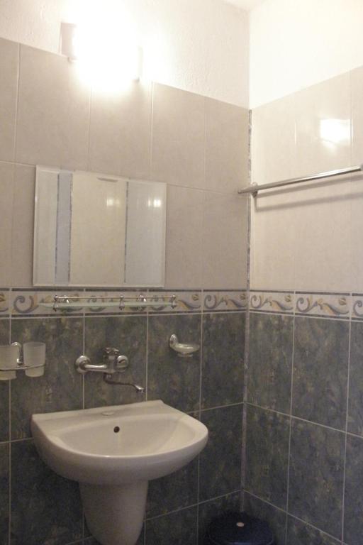 a bathroom with a sink and a mirror at Prestige in Sinemorets