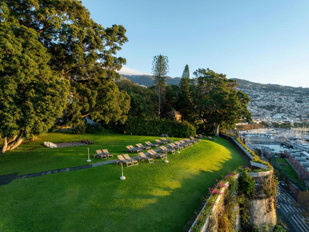a row of benches in a park next to a harbor at Pestana Casino Park Hotel & Casino in Funchal