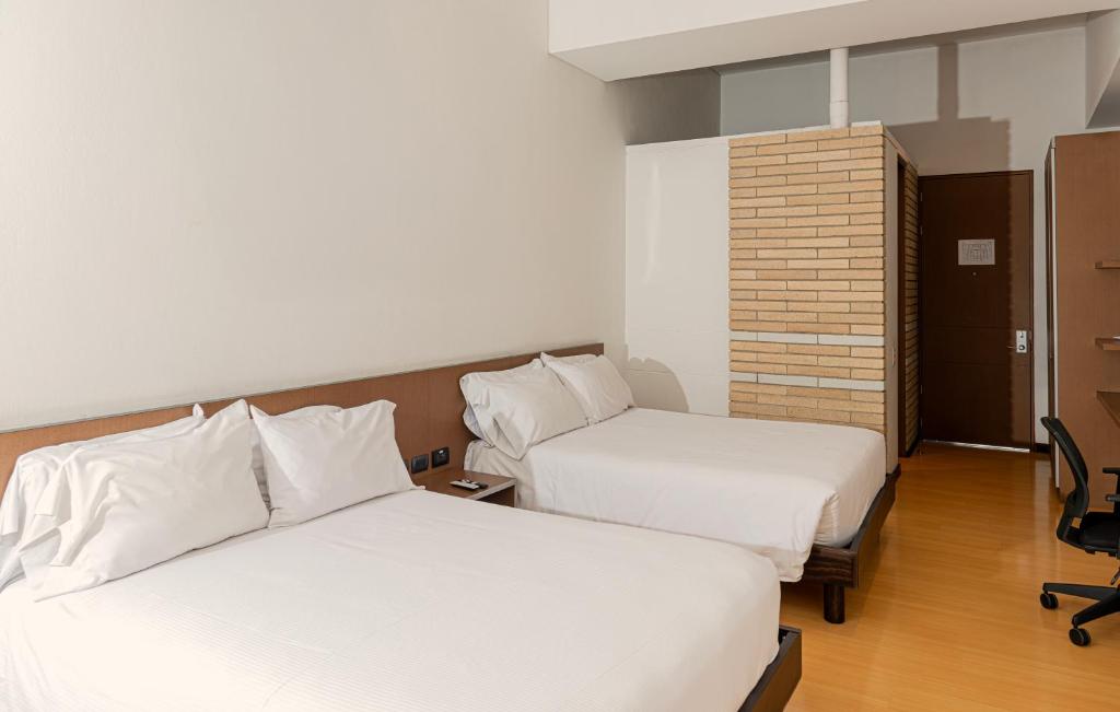 Postel nebo postele na pokoji v ubytování Hotel Viaggio Nueve Tres