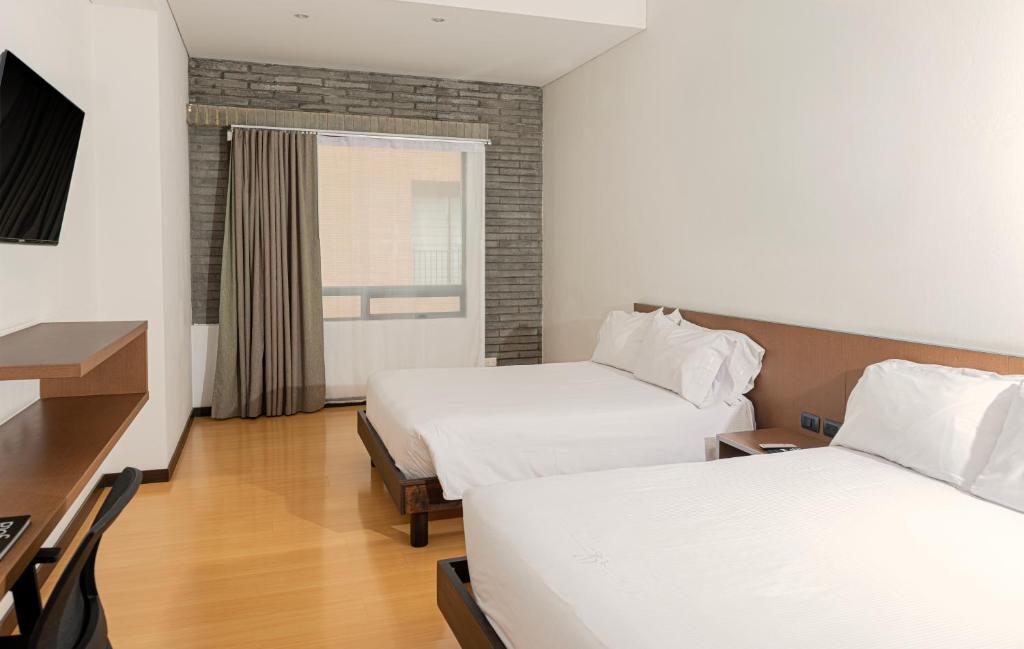 Postel nebo postele na pokoji v ubytování Hotel Viaggio Nueve Tres