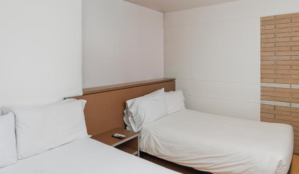Postel nebo postele na pokoji v ubytování Hotel Viaggio Nueve Tres