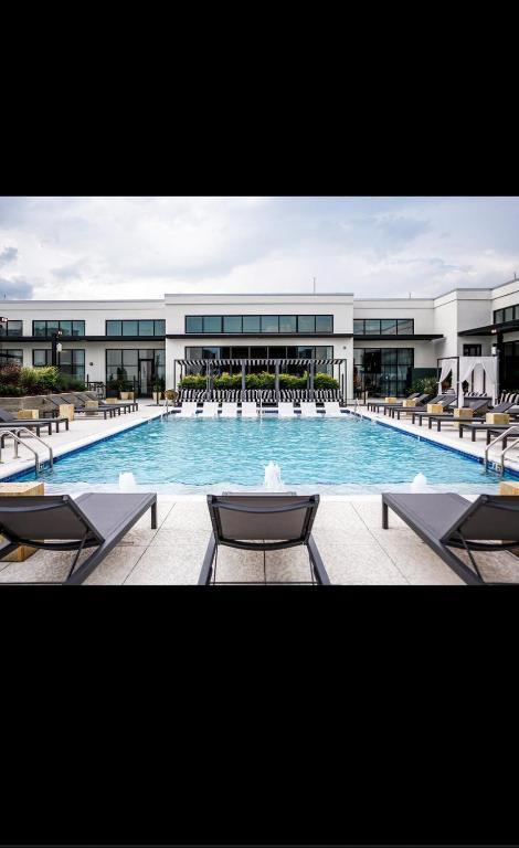 a large swimming pool with chairs and a building at Giaviana's in Atlanta