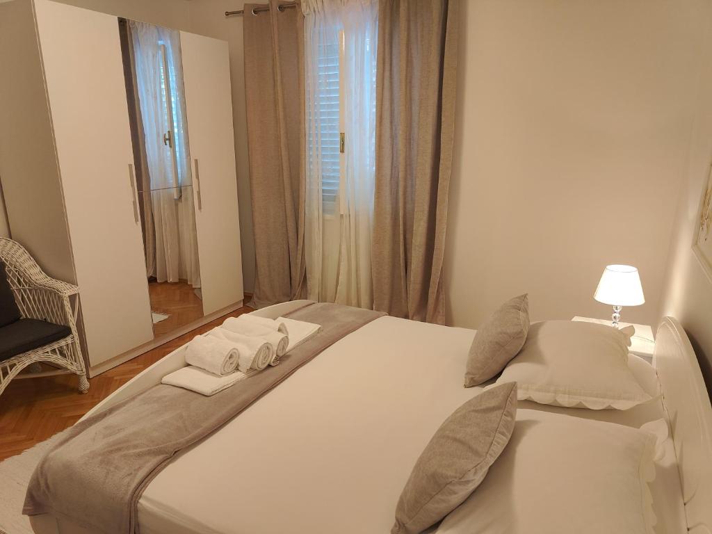 a large white bed in a room with a window at Apartment & bedroom D&M2 in Makarska