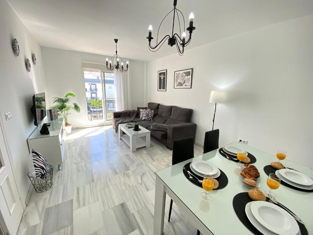a living room with a table and a couch at Apartamento Baluarte in Sanlúcar de Barrameda