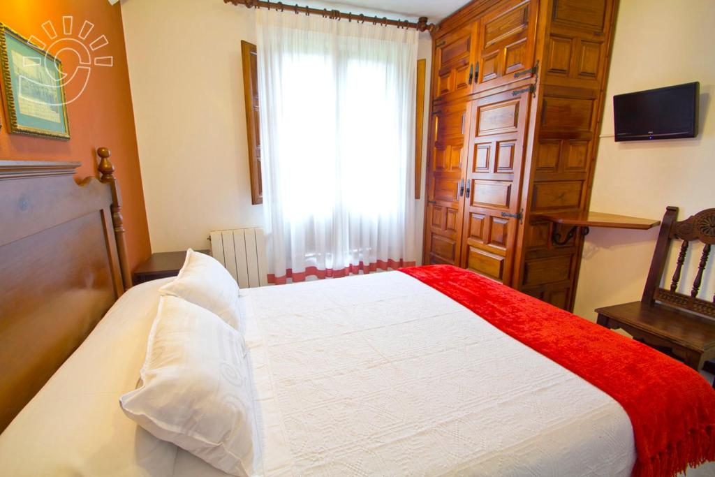 A bed or beds in a room at Posada Revolgo