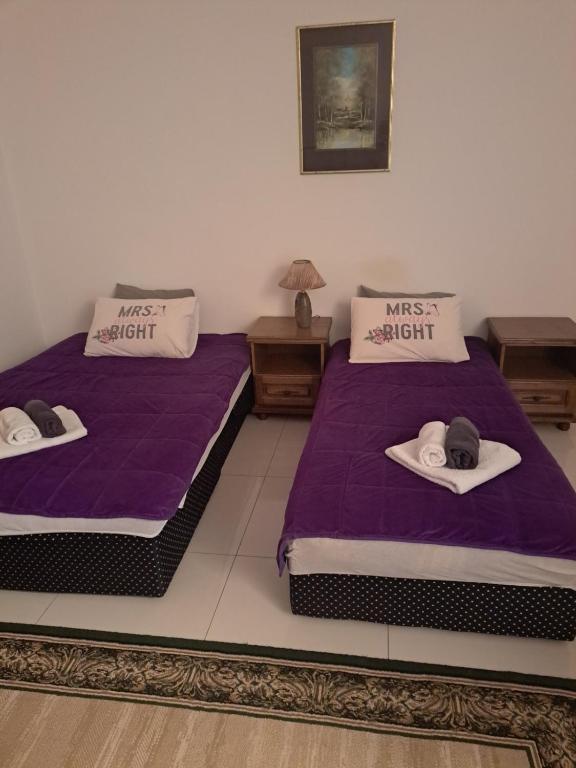 two beds with hats on them in a room at Koviljača park in Banja Koviljača