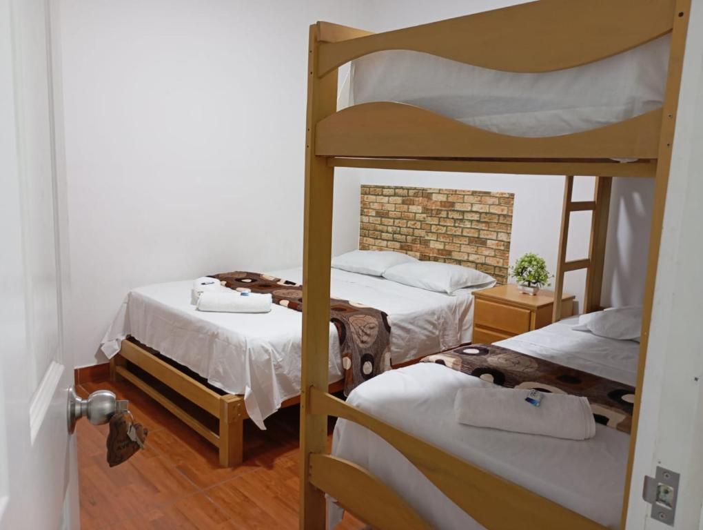 Postel nebo postele na pokoji v ubytování Hospedaje AYUVA