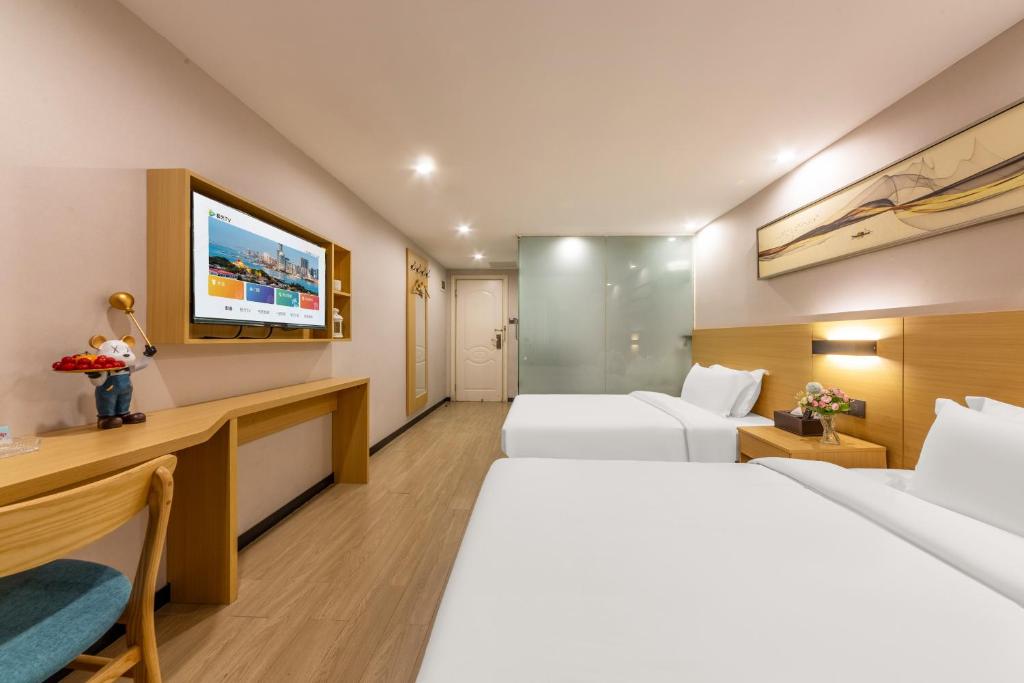 Postel nebo postele na pokoji v ubytování CMAX Hotel Guangzhou International Convention and Exhibition Center Luoxi Subway Station Branch