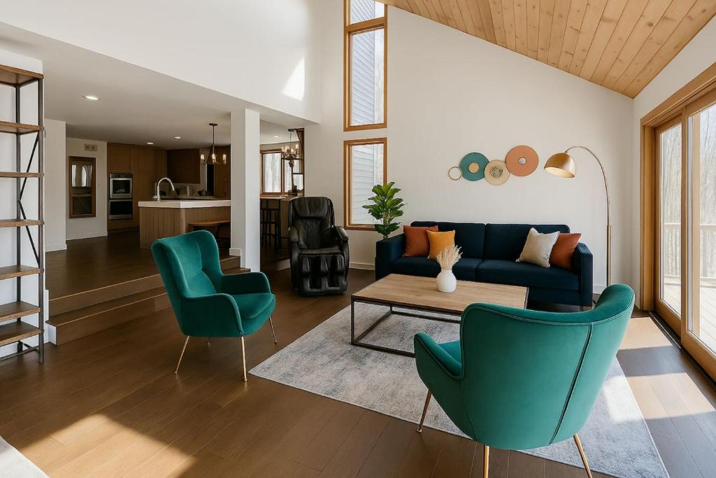 a living room with a blue couch and two chairs at Drift Haus 4.5BR Mountain Lodge in Windham