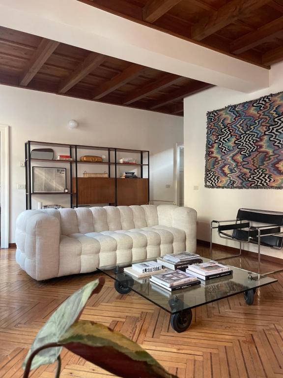 a living room with a white couch and a coffee table at Design lake apartment in Verbania