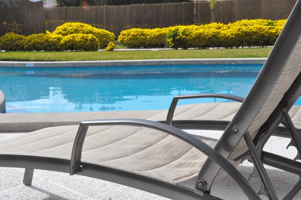 a chair sitting in front of a swimming pool at Ca Na Catalina in Pollença