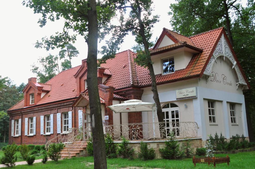 a large house with a red roof at Dwór Carski in Spała