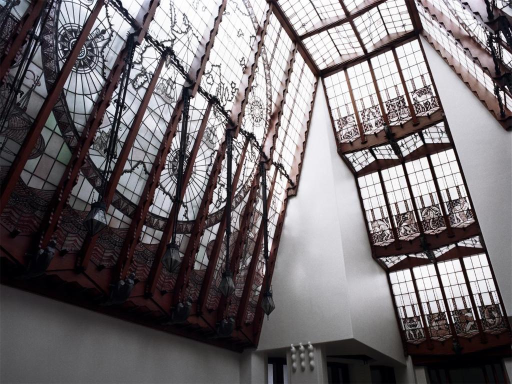 a room with large windows and wrought iron balconies at Grand Hotel Amrâth Amsterdam in Amsterdam