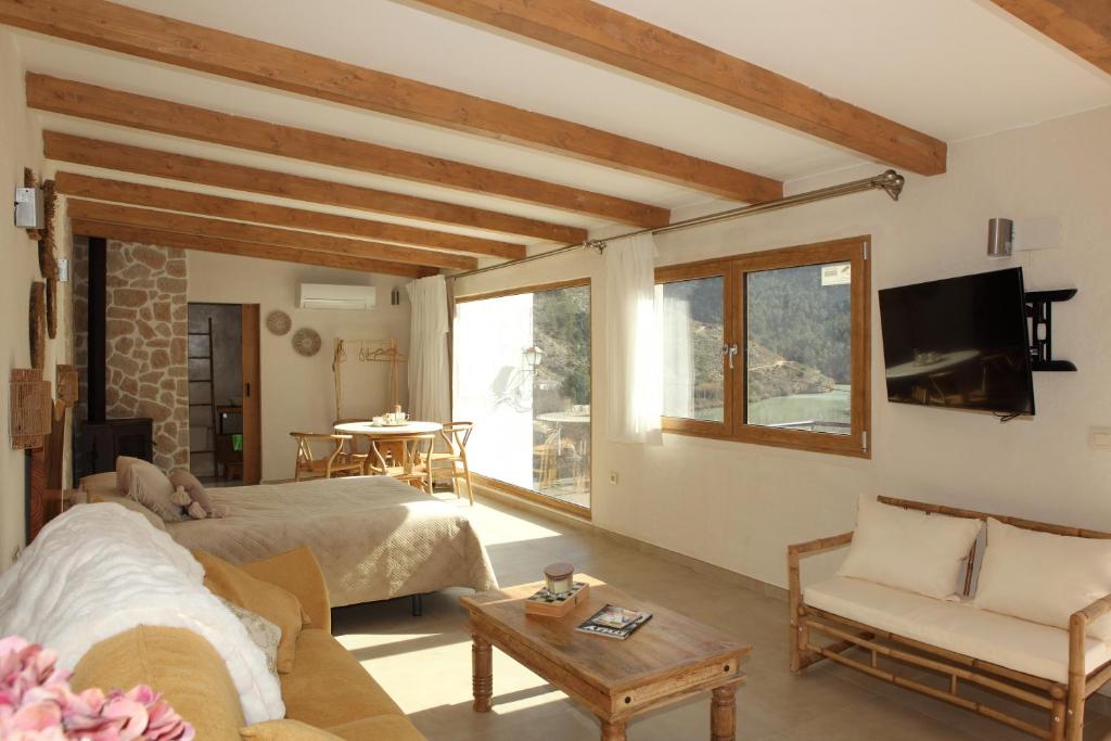 a living room with a bed and a couch and a tv at Bella Vista Suit Casas Lacambra in Tolosa