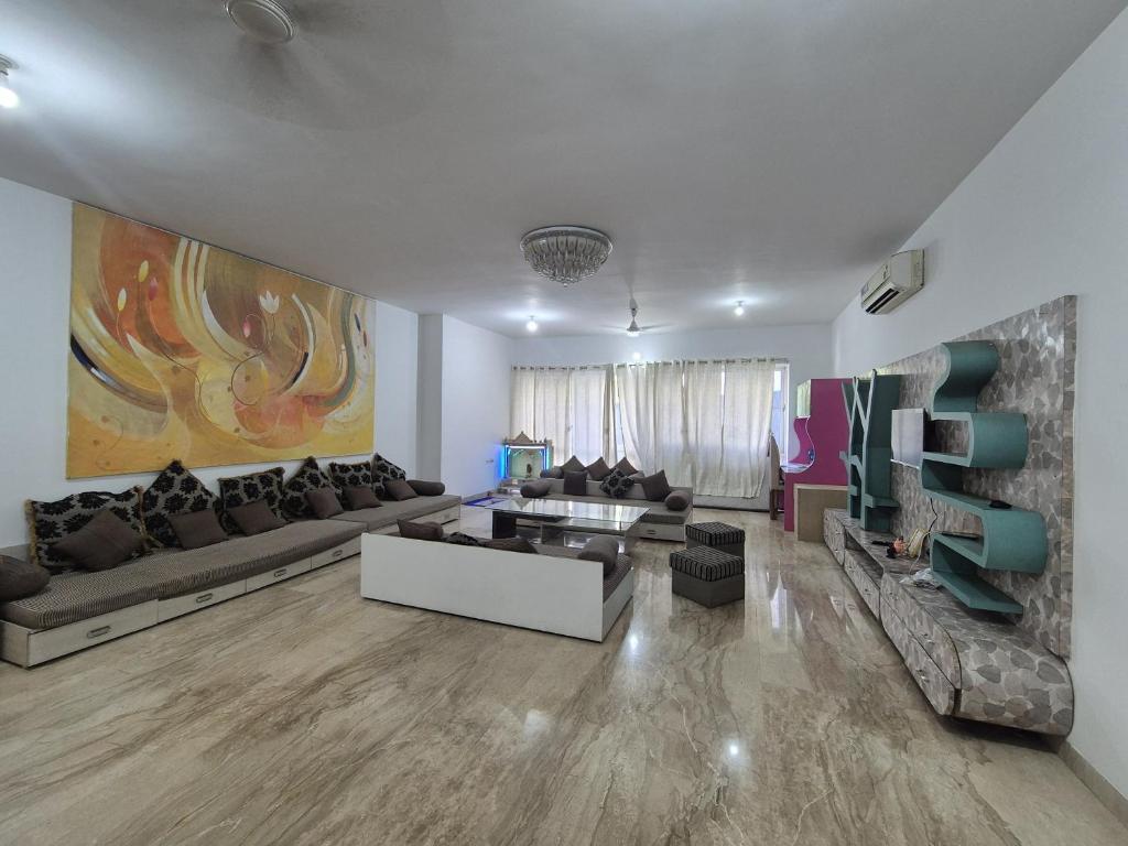 a living room with a couch and a table at Elite Stays -Viman Nagar in Pune