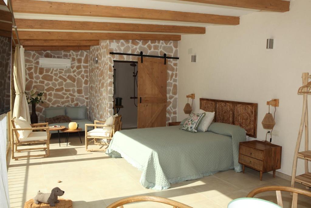 a bedroom with a bed and a table and chairs at Paraiso Suit Casas Lacambra in Tolosa