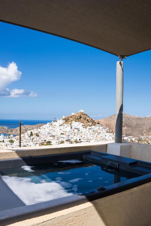 a view from the balcony of a villa with a swimming pool at Wabi Luxury Suites & Maisonettes Ios in Ios Chora
