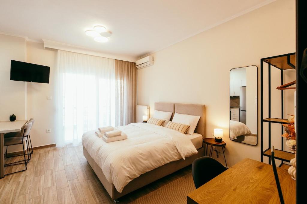a bedroom with a bed and a desk and a mirror at Cozy apartment HouseNest in Serres
