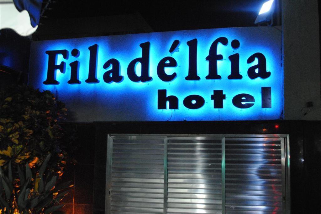 a blue hotel sign on the side of a building at Filadelfia Hotel in São Paulo