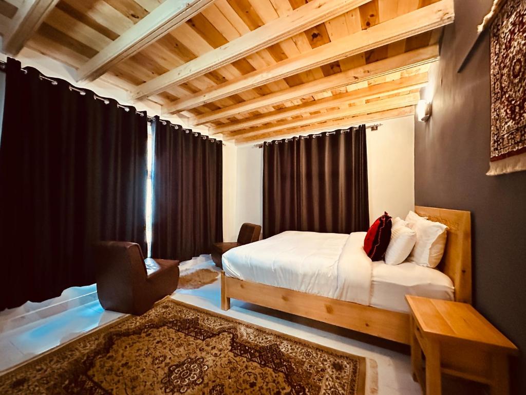 a bedroom with a bed and a table and a room at North Vibe Resort Hunza in Hunza Valley