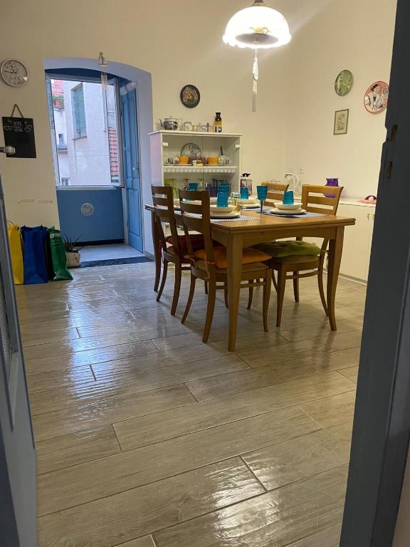 a dining room with a wooden table and chairs at La CIASSA 00942-LT-0372 in Noli
