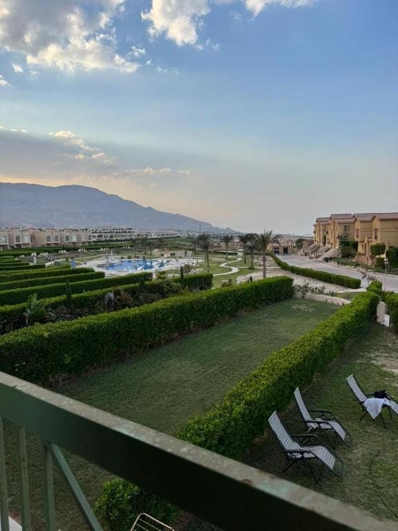 a view from a balcony of a park with chairs at ڤيلا بجاردن في كومبوند لاڤيستا توباز العين السخنه in Ain Sokhna