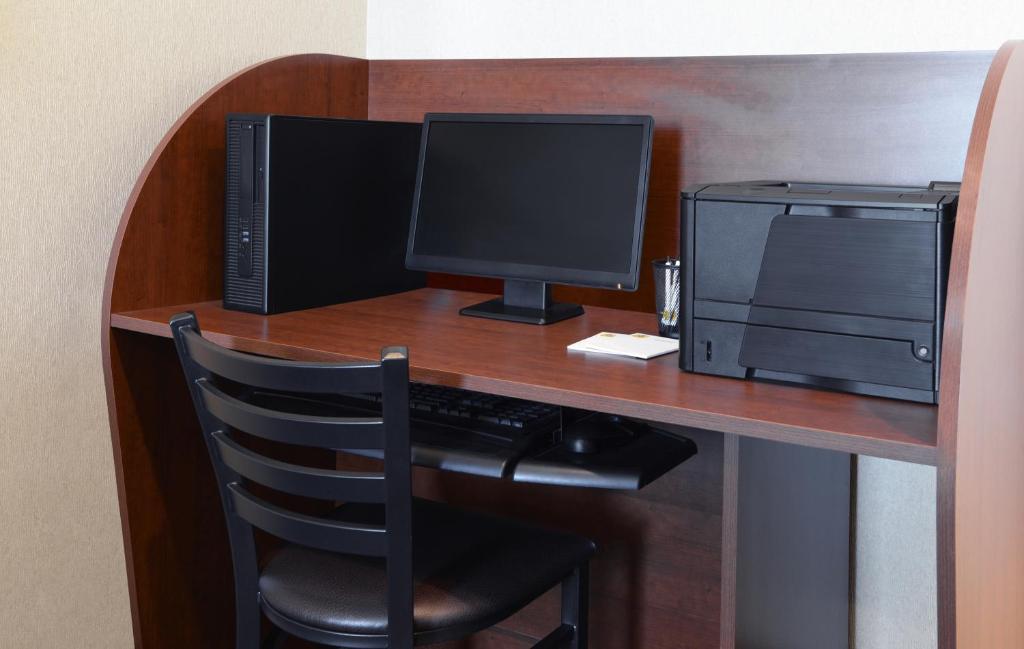 a desk with a computer monitor and a printer at My Place Hotel Rapid City in Rapid City