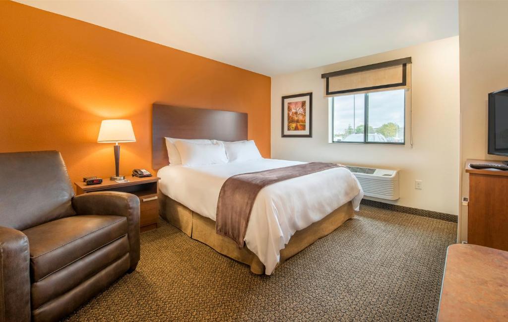 a hotel room with a bed and a chair at My Place Hotel-Lubbock, TX in Lubbock