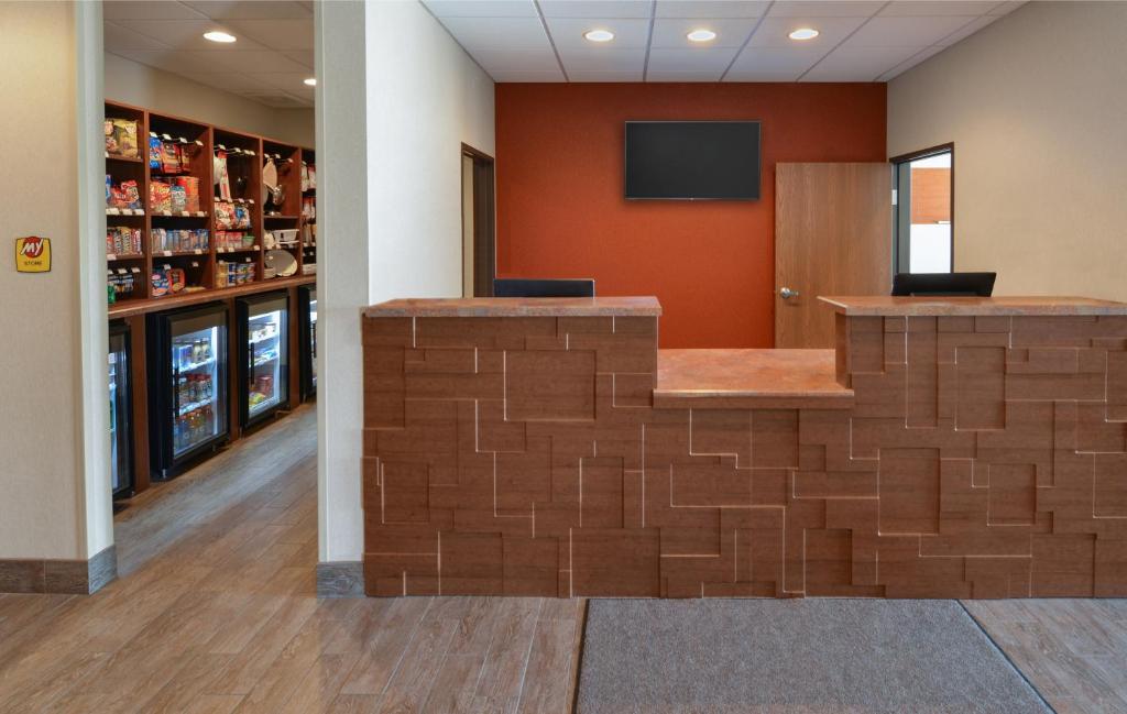 a lobby with a wall made out of brick at My Place Hotel-Lubbock, TX in Lubbock