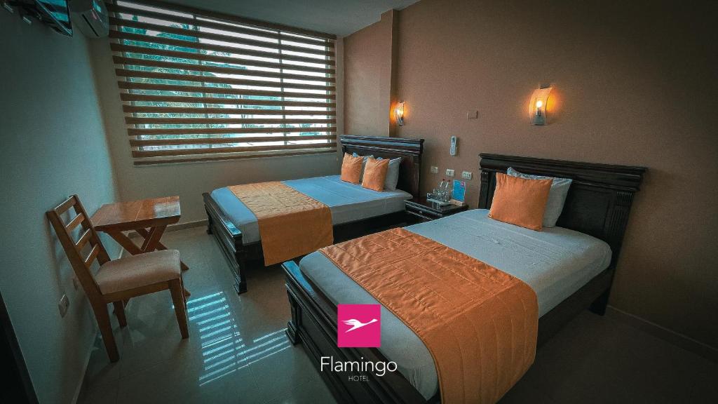 Postel nebo postele na pokoji v ubytování Hotel Flamingo