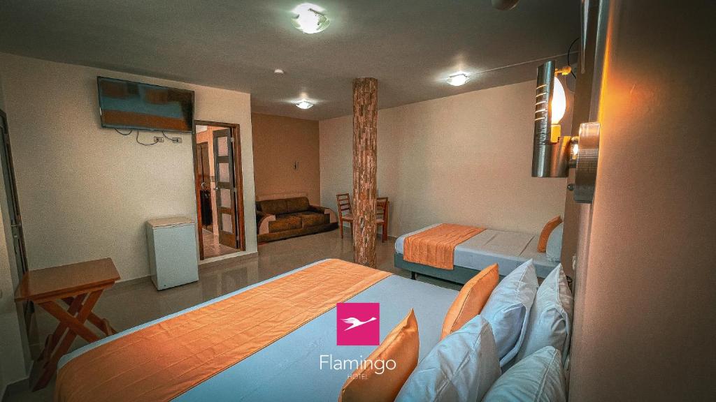 Postel nebo postele na pokoji v ubytování Hotel Flamingo
