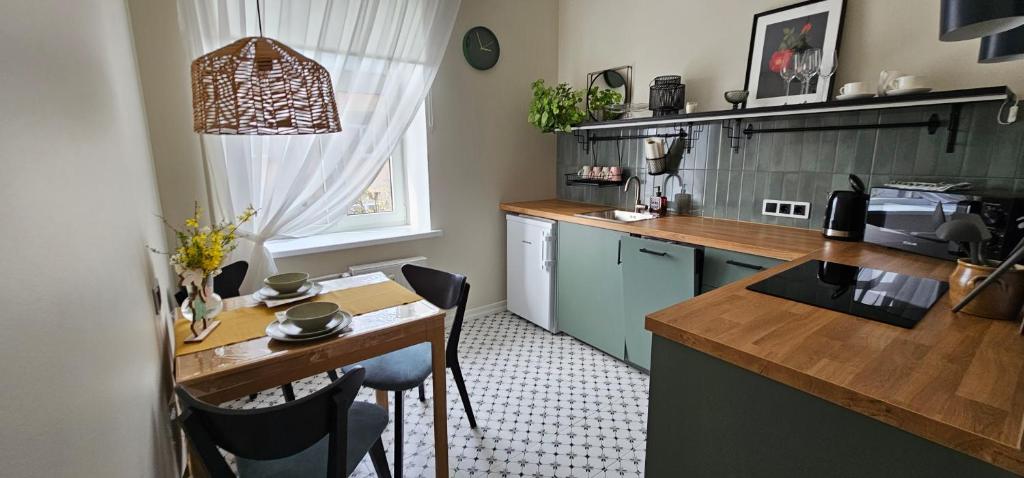 a kitchen with a table and a counter top at House of the Sun in Ventspils